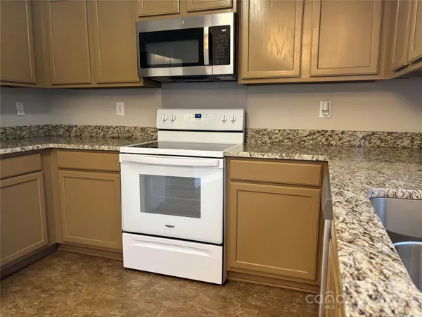 a kitchen with a stove and a microwave