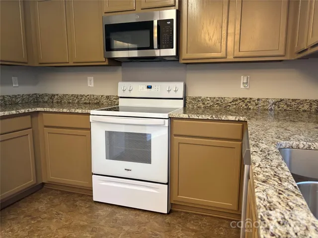 a kitchen with a stove and a microwave