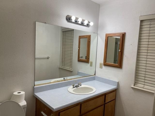 1240 Seneca Drive Madera, CA 93637 - Photo 14 of 21 a bathroom with a granite countertop sink and a mirror