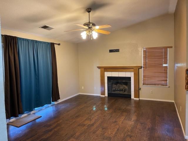 1240 Seneca Drive Madera, CA 93637 - Photo 7 of 21 a view of an empty room with wooden floor fireplace and a window