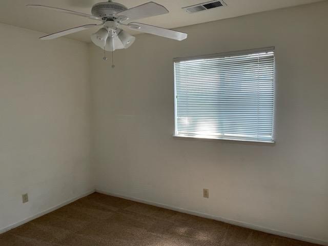 1240 Seneca Drive Madera, CA 93637 - Photo 10 of 21 an empty room with a window and a fan