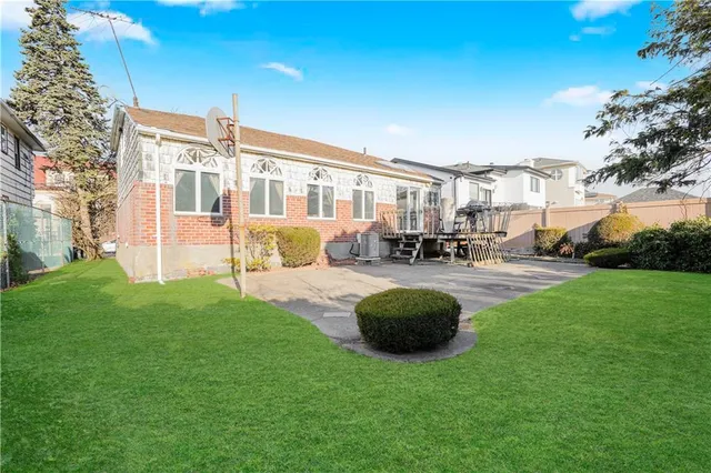 a swimming pool with outdoor seating and garden
