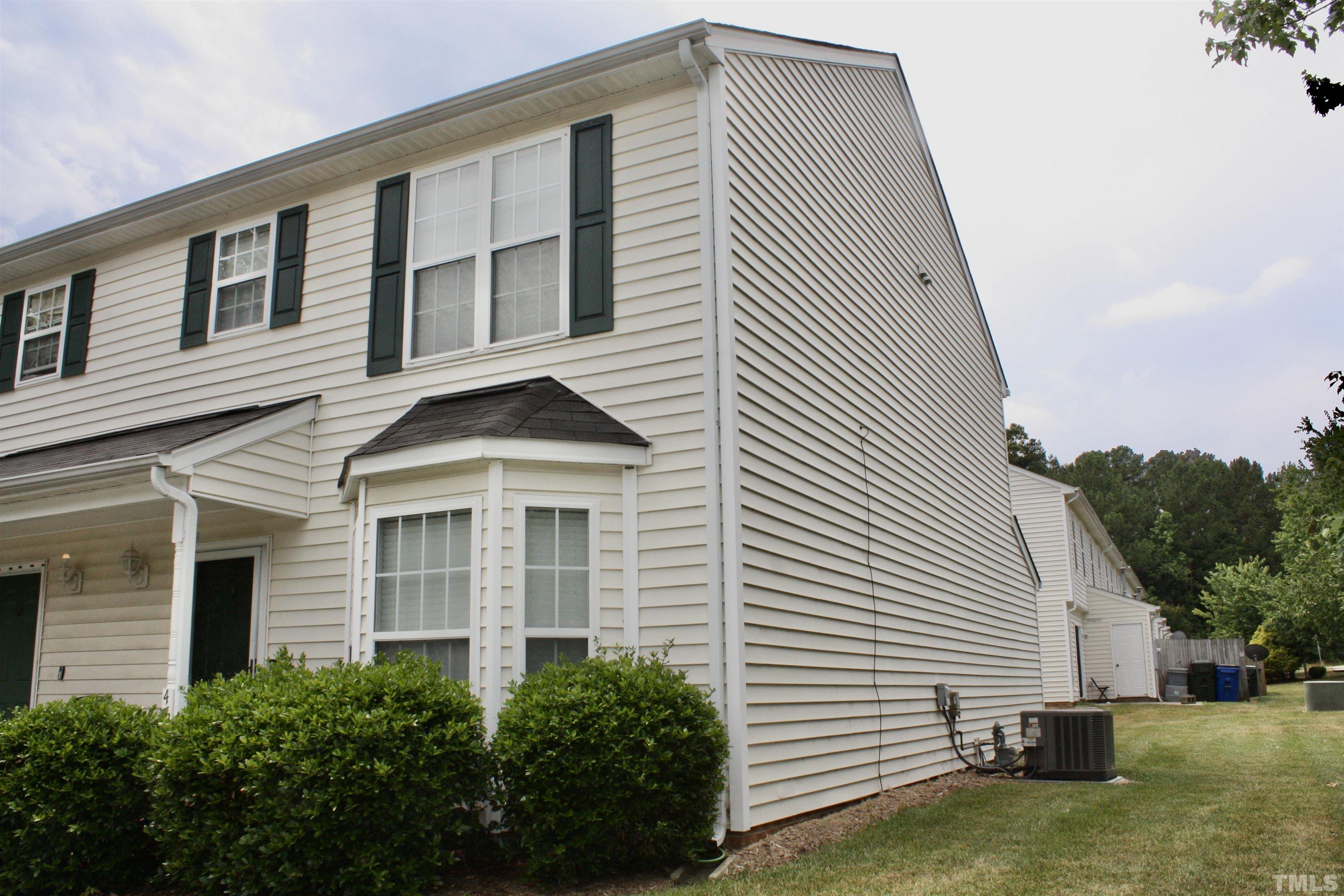 4702 Tanglewood Oaks Street Raleigh, NC 27610 - Photo 1 of 11 a front view of a house with a yard