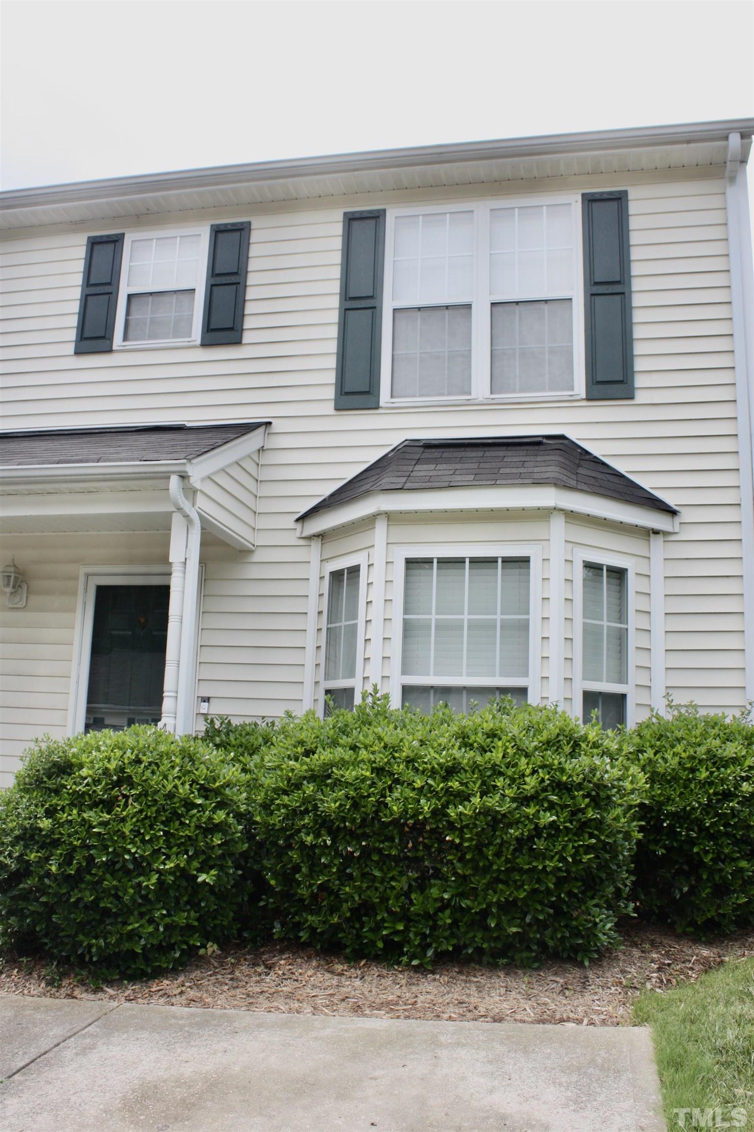 4702 Tanglewood Oaks Street Raleigh, NC 27610 - Photo 2 of 11 a front view of a house with a garden