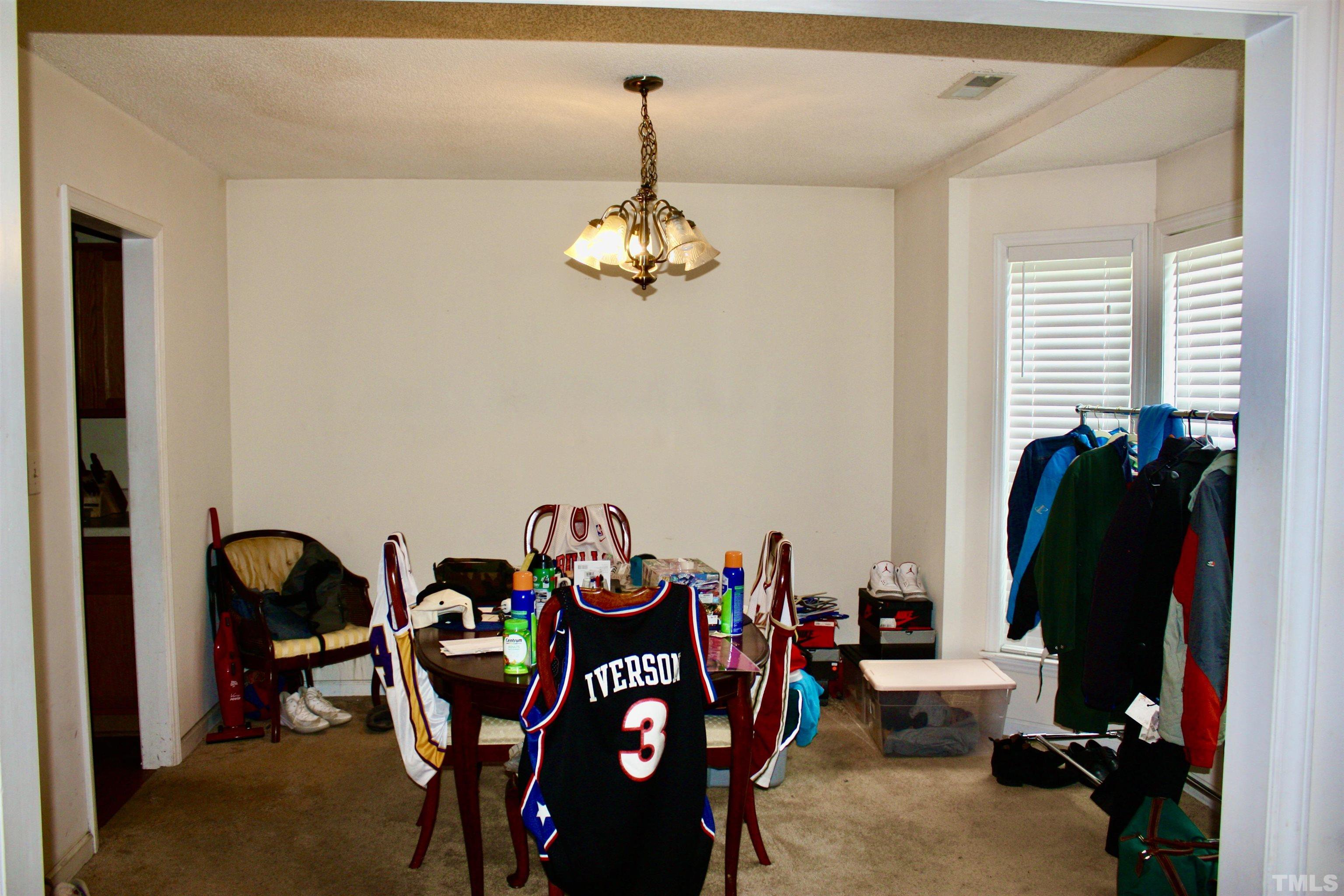 4702 Tanglewood Oaks Street Raleigh, NC 27610 - Photo 6 of 11 a view of a dining room with furniture and a chandelier