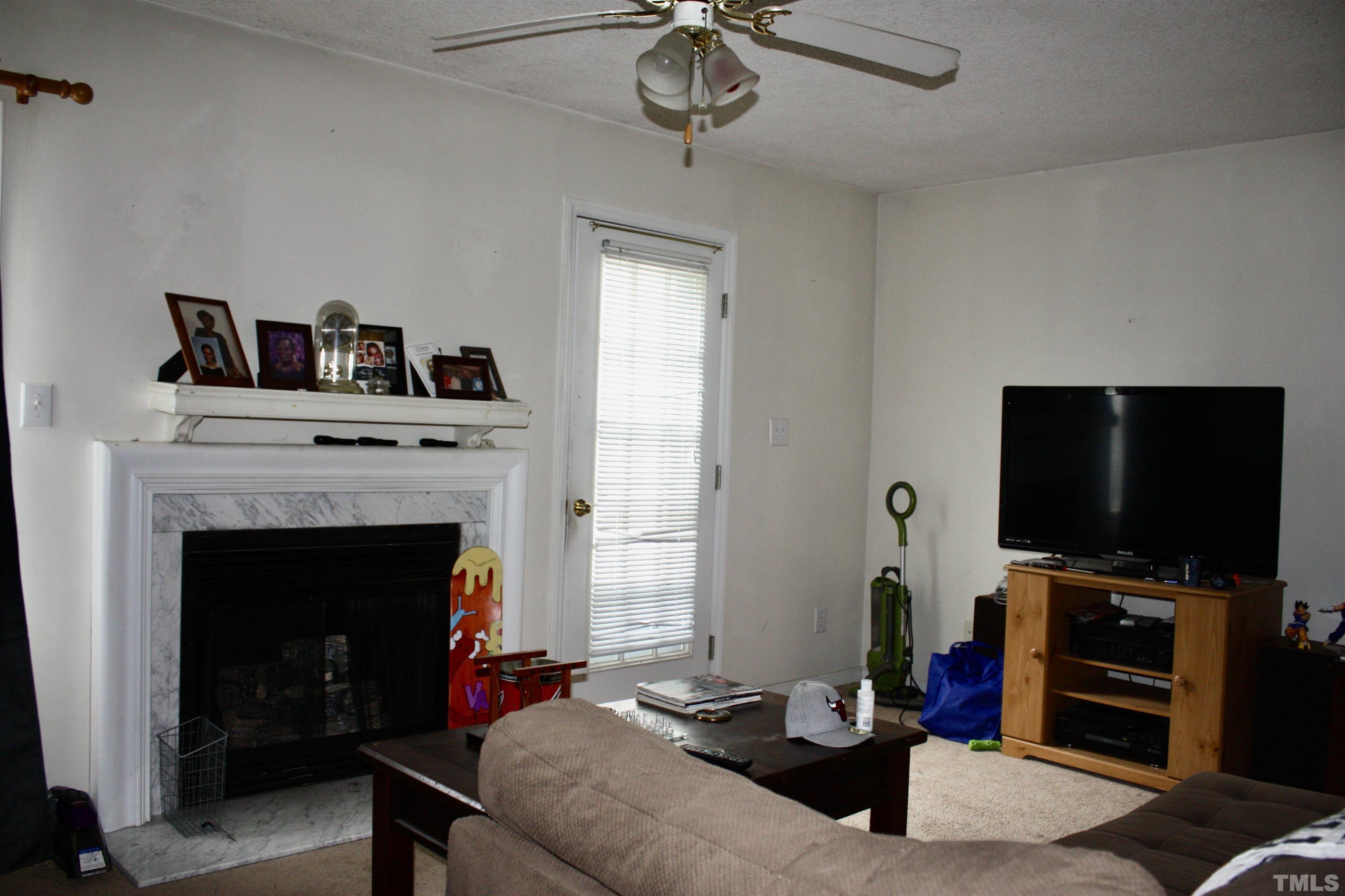 4702 Tanglewood Oaks Street Raleigh, NC 27610 - Photo 7 of 11 a living room with furniture and a fireplace