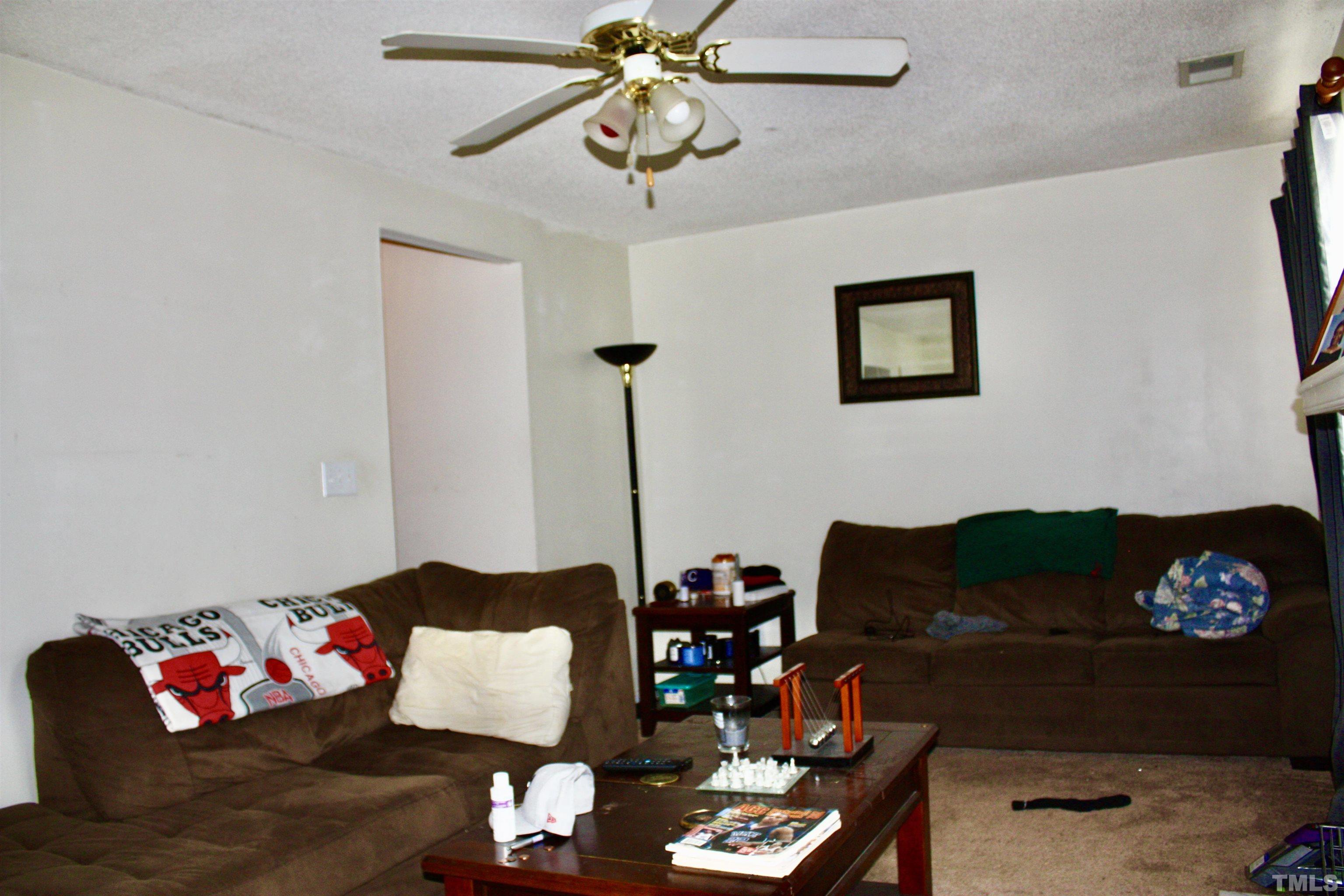 4702 Tanglewood Oaks Street Raleigh, NC 27610 - Photo 8 of 11 a living room with furniture and a lamp