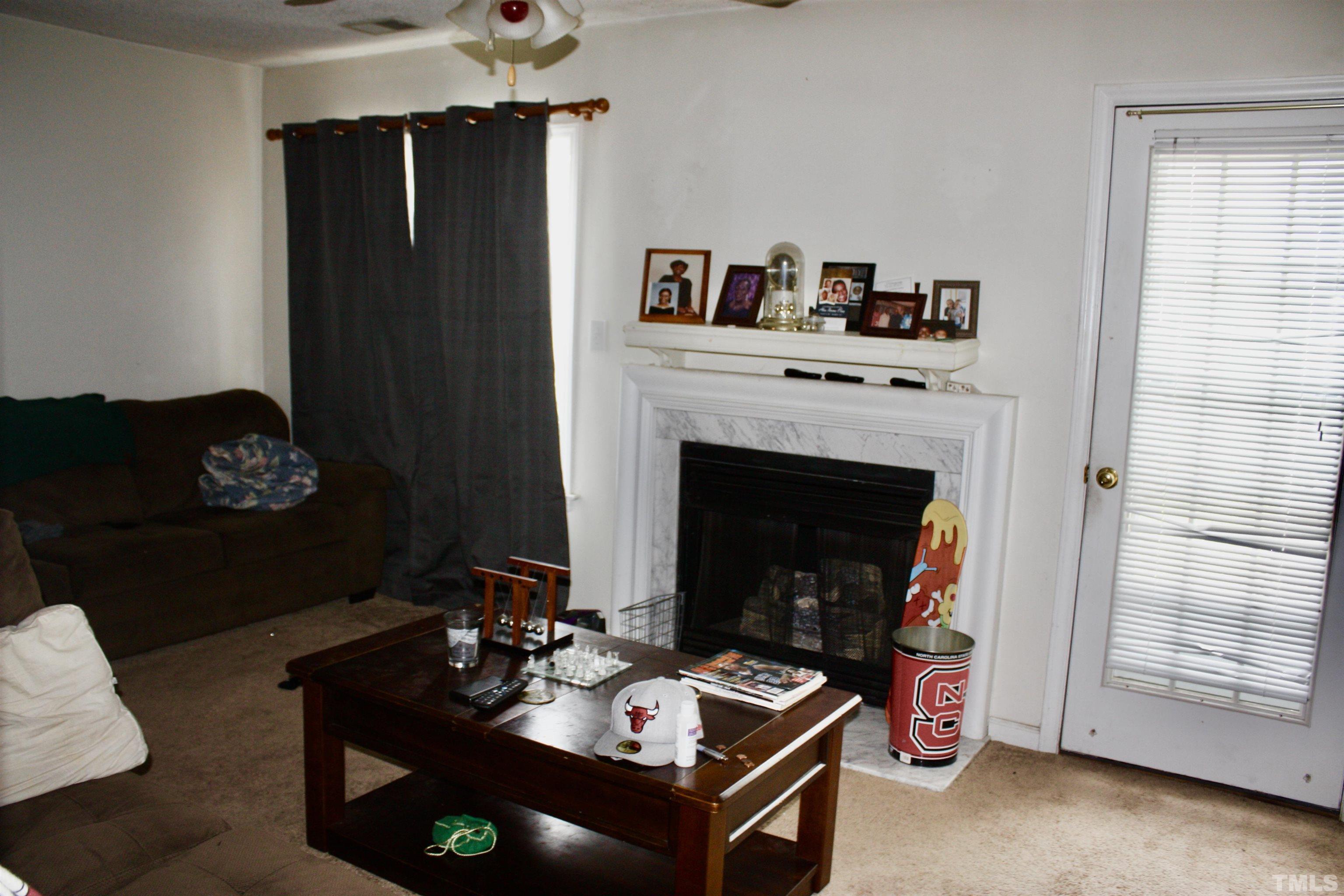 4702 Tanglewood Oaks Street Raleigh, NC 27610 - Photo 9 of 11 a living room with furniture and a fireplace