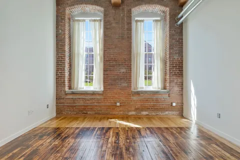 a view of a brick house with windows