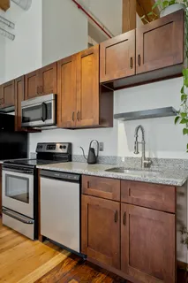a kitchen with stainless steel appliances granite countertop a sink and a microwave