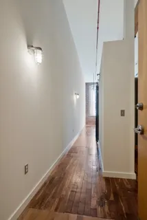a view of a hallway with wooden floor
