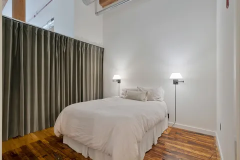 a bedroom with a bed and a night stand