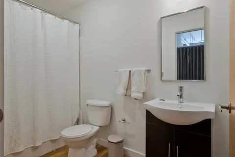 a bathroom with a sink toilet and vanity