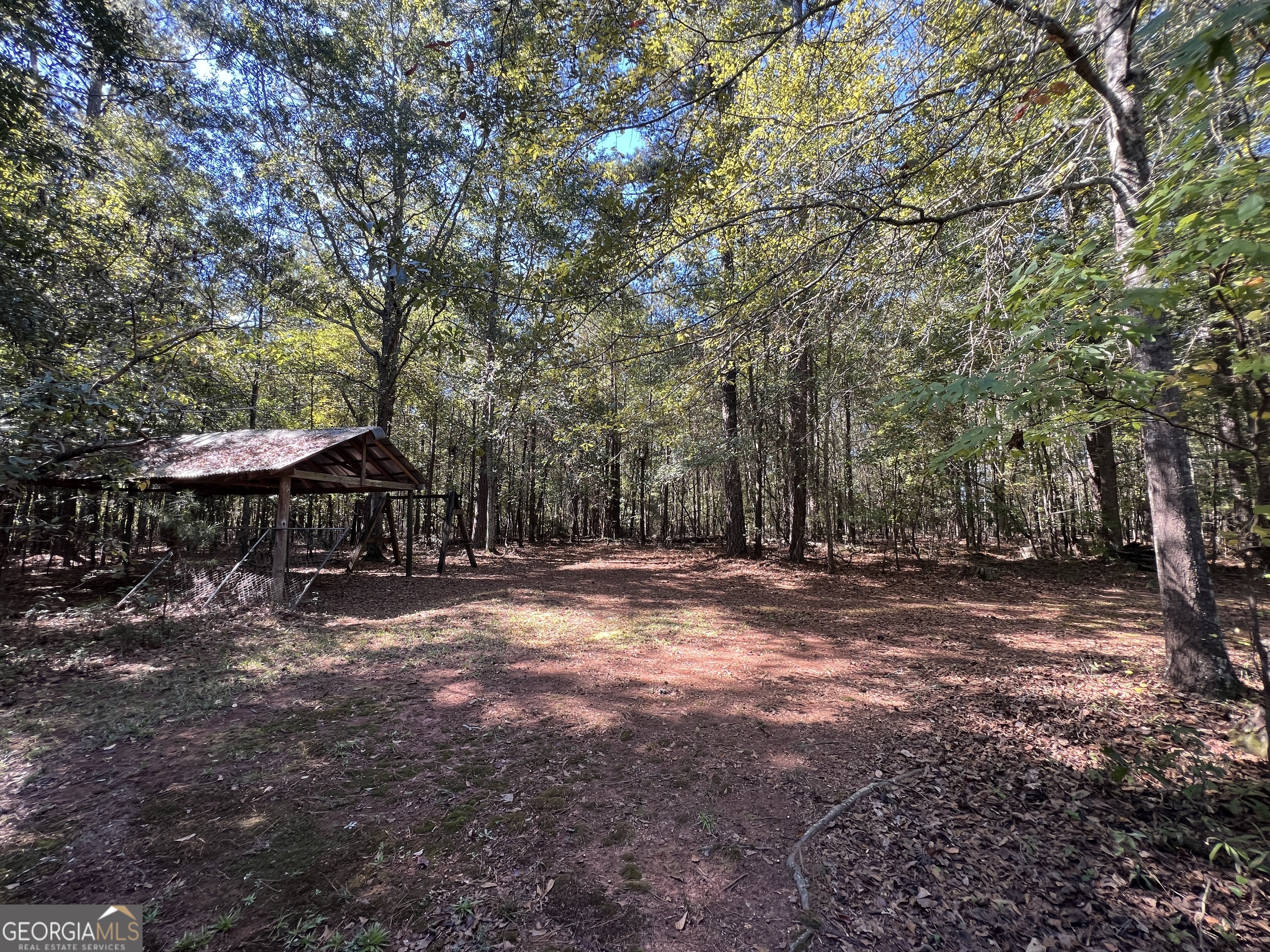 1500 Pine Forest Road Mansfield, GA 30055 - Photo 17 of 47 a view of a yard with a table and chairs under an umbrella