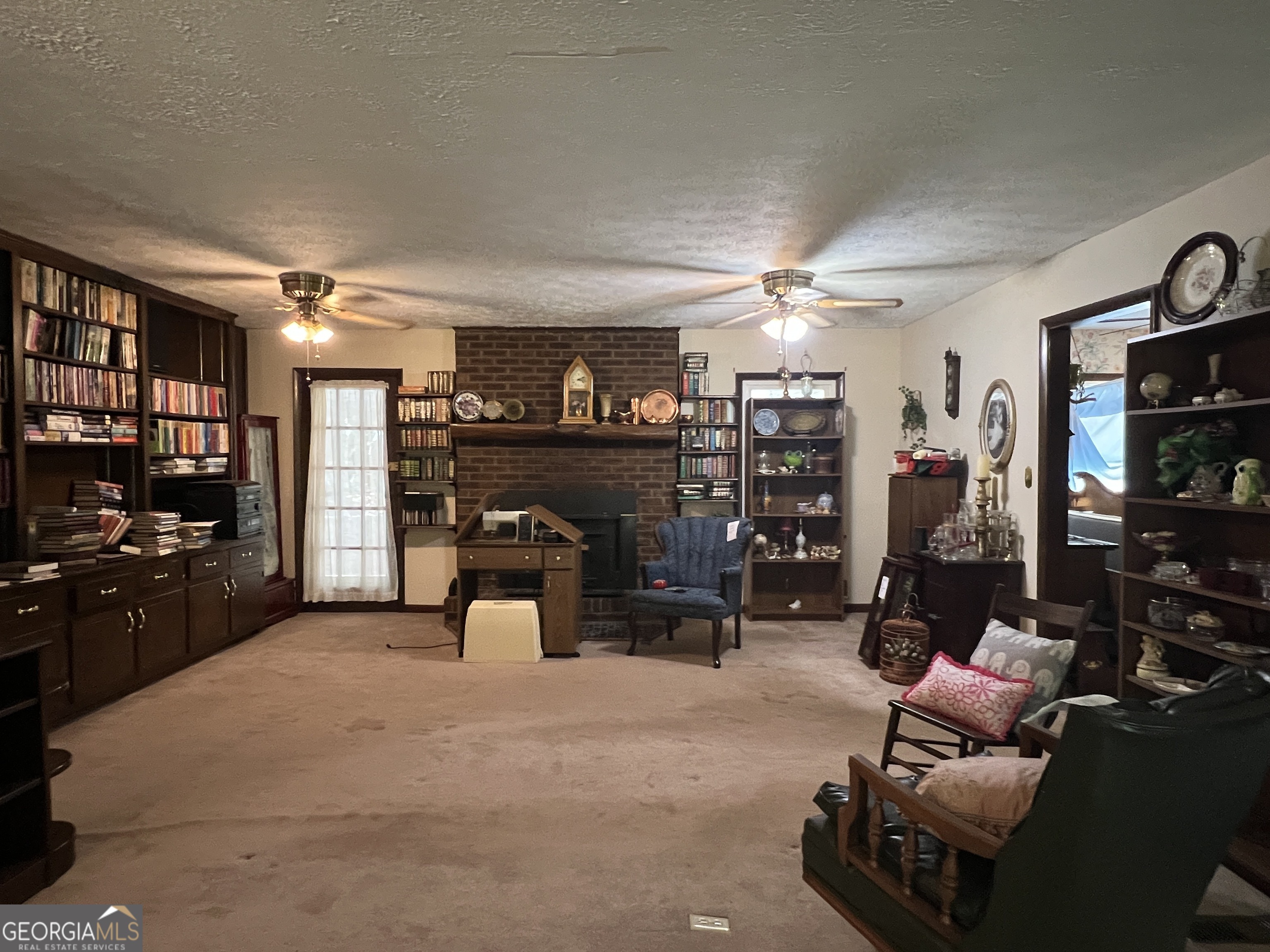 1500 Pine Forest Road Mansfield, GA 30055 - Photo 38 of 47 a living room with furniture a flat screen tv and a fireplace