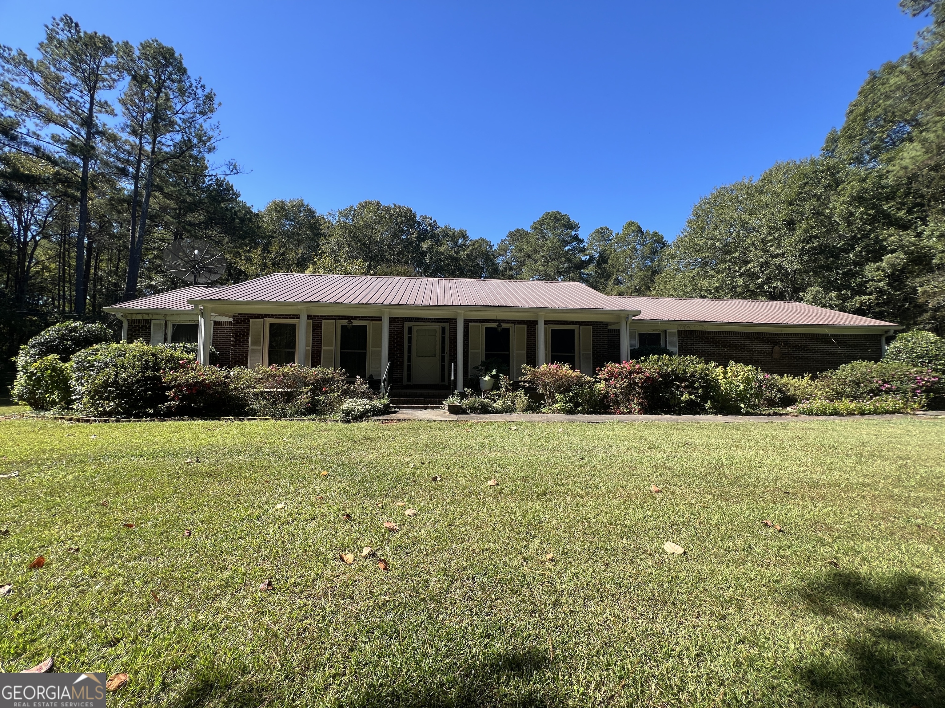 1500 Pine Forest Road Mansfield, GA 30055 - Photo 4 of 47 a front view of a house with a yard table and porch
