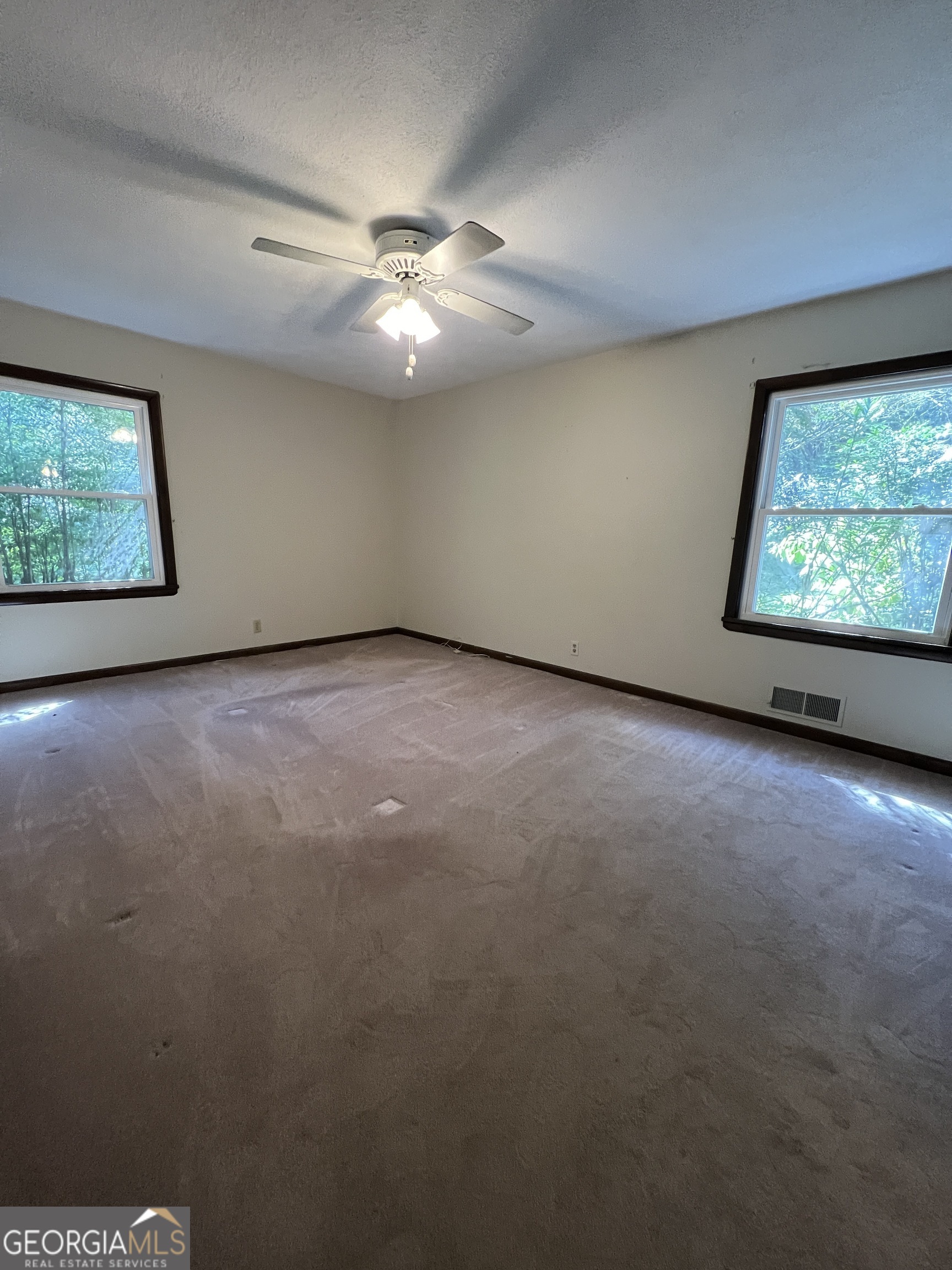 1500 Pine Forest Road Mansfield, GA 30055 - Photo 45 of 47 an empty room with windows and fan