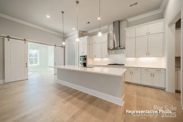 a large white kitchen with a large window