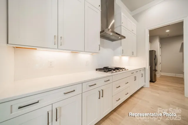 a kitchen with stainless steel appliances white cabinets and a sink