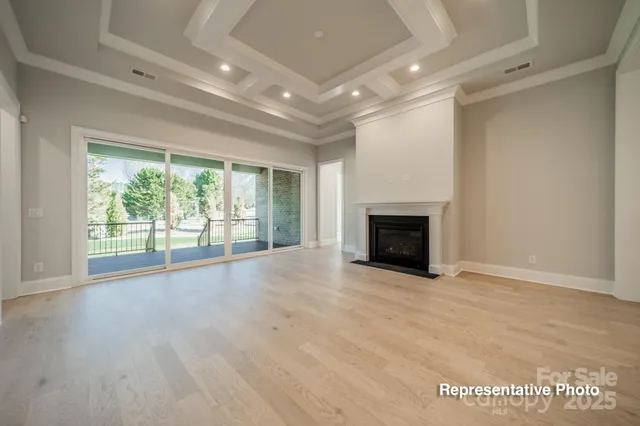 an empty room with wooden floor and fireplace