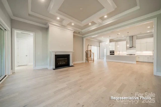 a view of a hallway with stainless steel appliances large windows