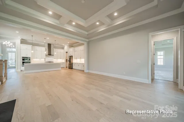 a view of a living room a kitchen and a sink