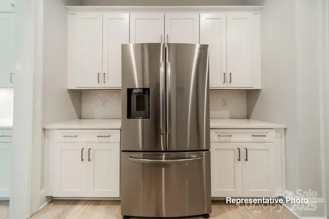 a kitchen with cabinets and stainless steel appliances