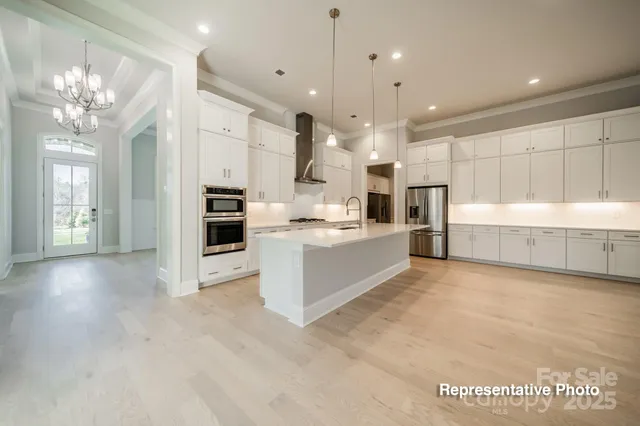 a large kitchen with cabinets and stainless steel appliances