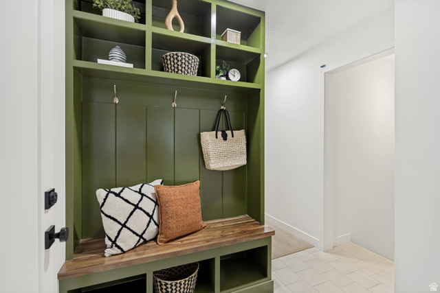 1168 East Center Street Bountiful, UT 84010 - Photo 12 of 38 Built-in entryway storage featuring a custom green finish, natural wood bench, integrated shelving, and metal hooks