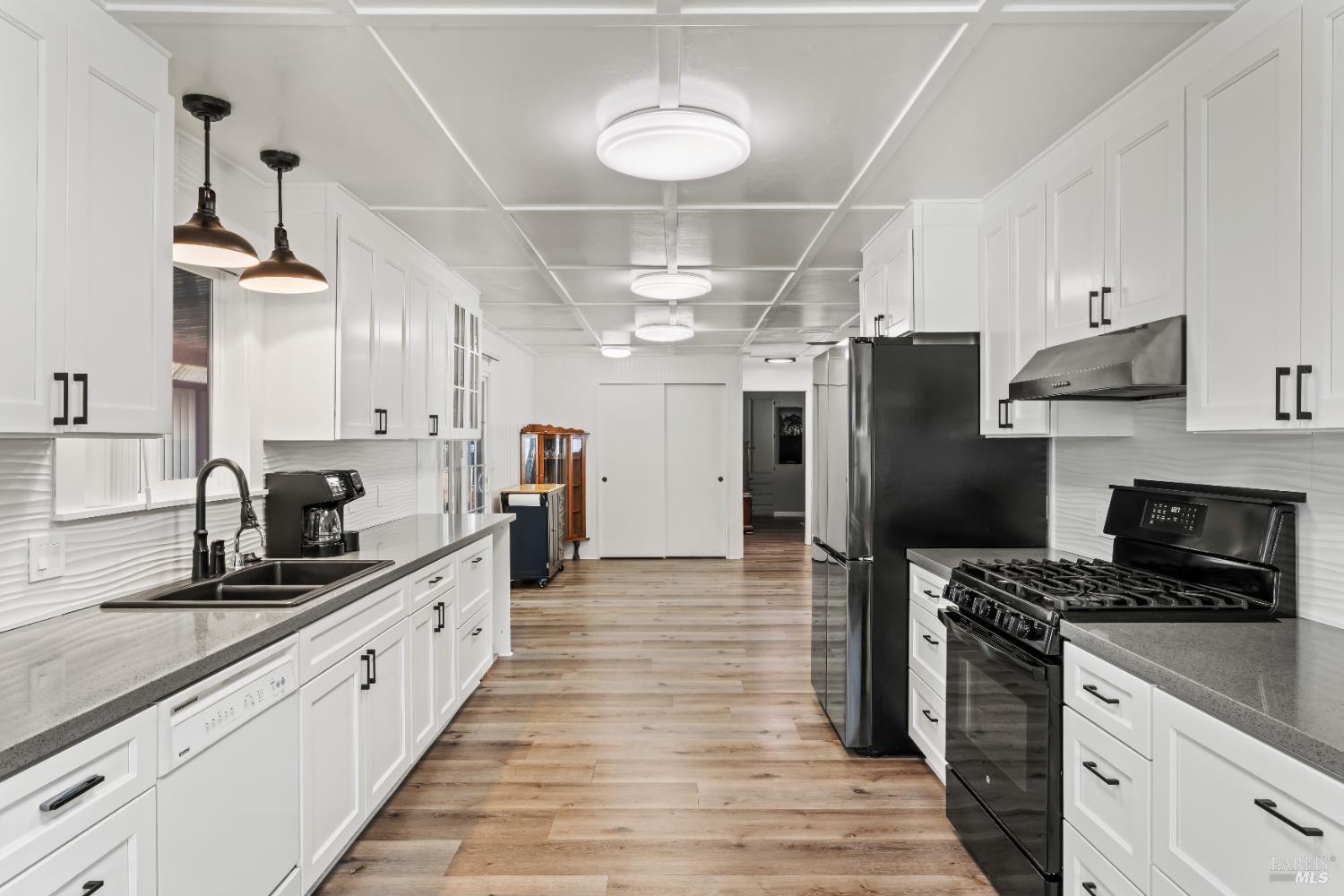 a kitchen with stainless steel appliances a sink stove and refrigerator