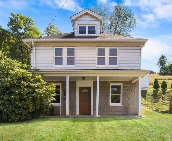 front view of a house with a yard