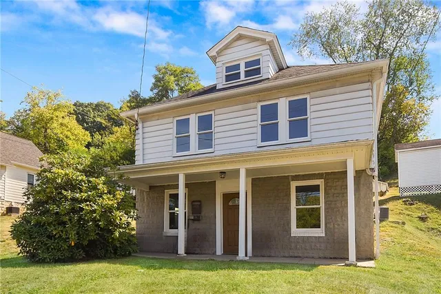 a front view of a house with a yard