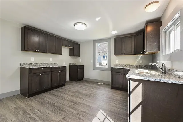 a kitchen with a stove top oven sink and cabinets
