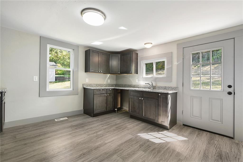 808 Mill Street Bridgeville, PA 15017 - Photo 10 of 27 a kitchen with stainless steel appliances granite countertop a stove a sink and a refrigerator