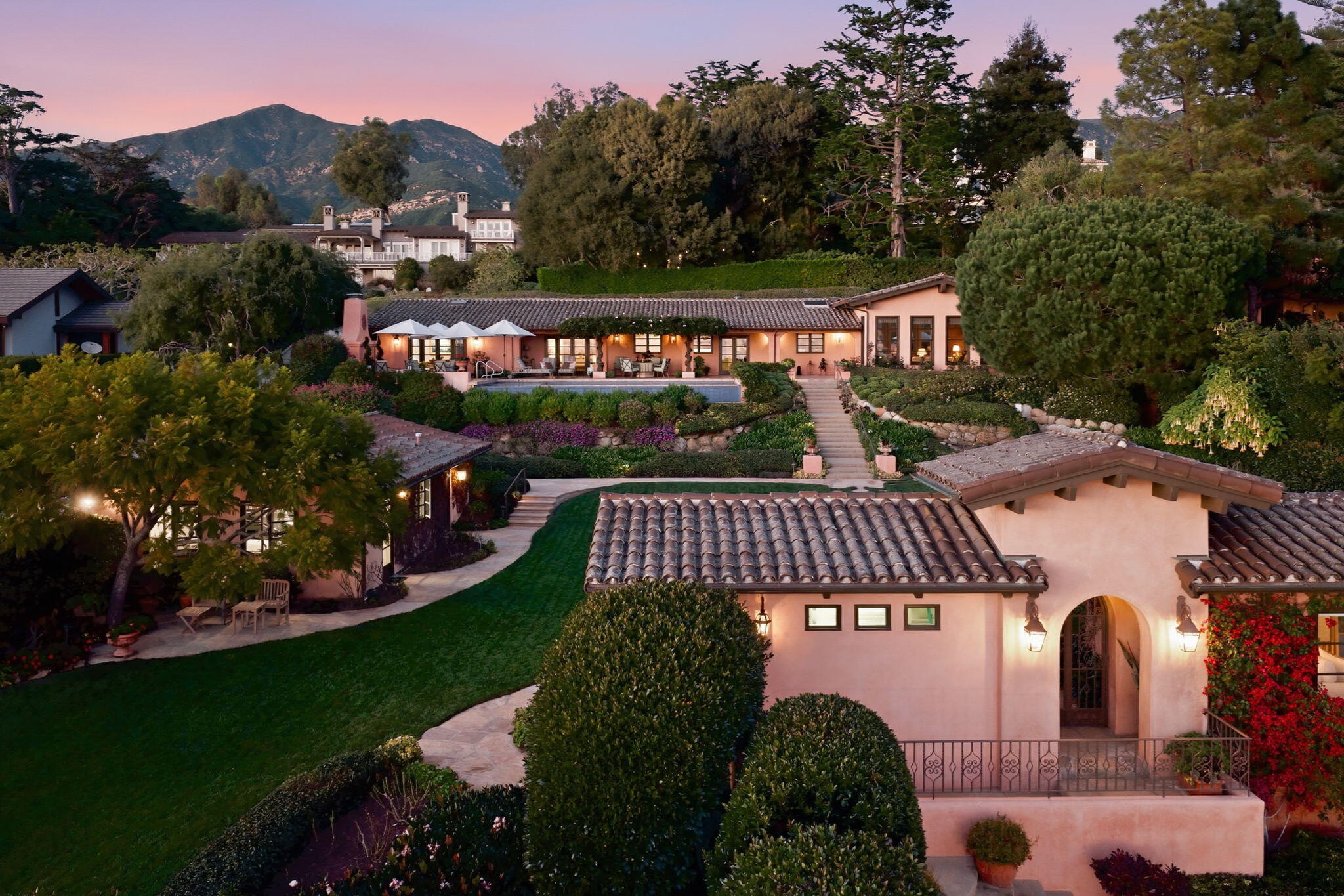 a view of a street with a park that has a lots of bushes