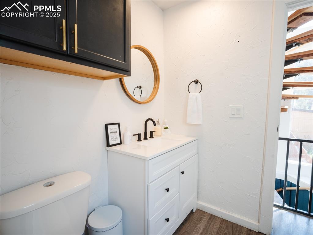 57 Granite Road Florissant, CO 80816 - Photo 20 of 46 a bathroom with a toilet sink vanity and mirror