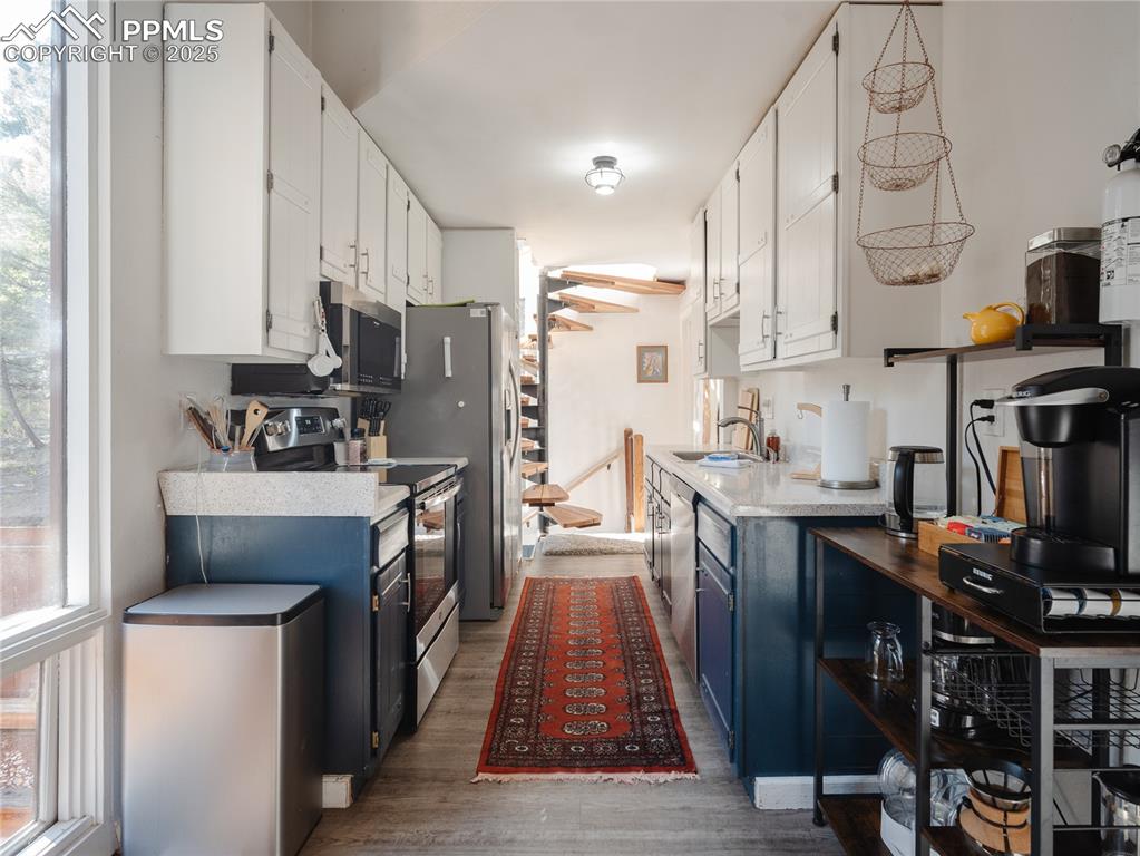 57 Granite Road Florissant, CO 80816 - Photo 21 of 46 a kitchen with stainless steel appliances a stove a sink and a refrigerator