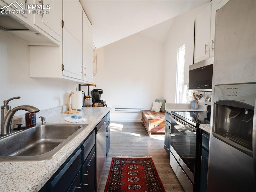 57 Granite Road Florissant, CO 80816 - Photo 22 of 46 a kitchen with a sink stove top oven and microwave