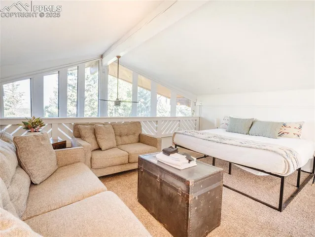 a large bedroom with two beds and a large window