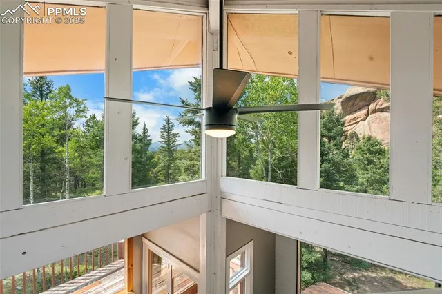 a view of a bedroom with wooden floor and a window