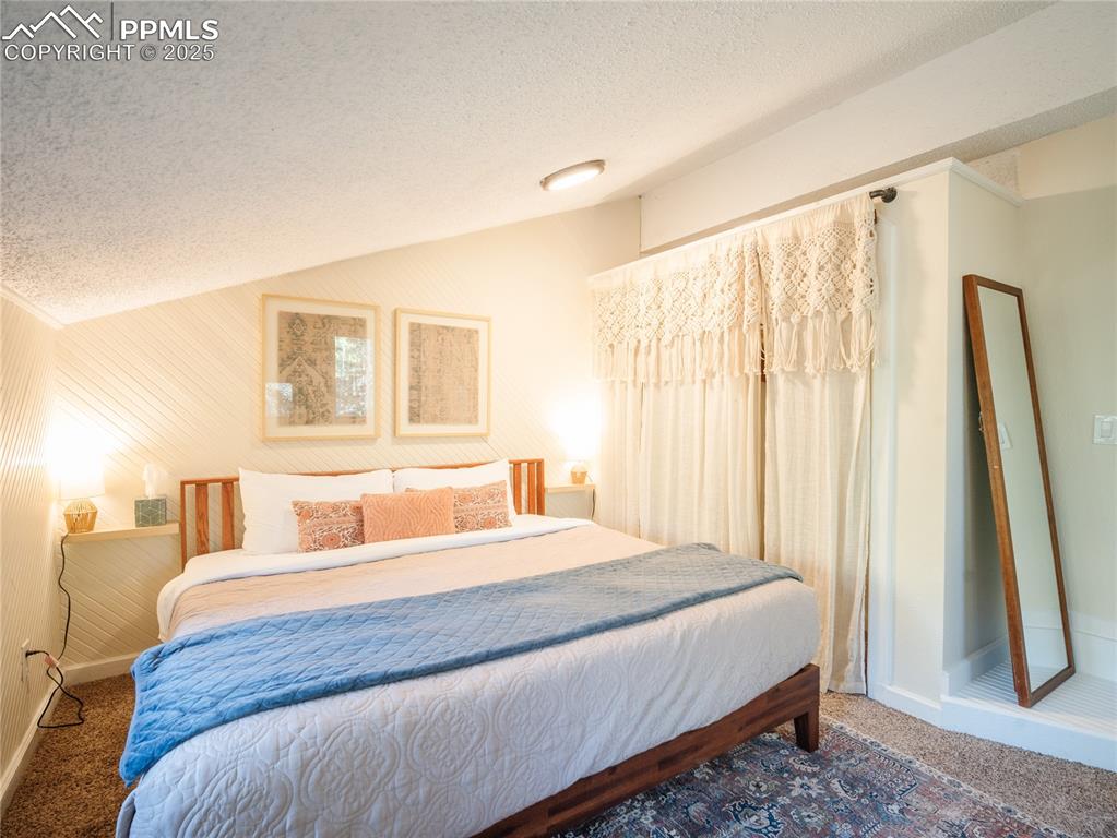 57 Granite Road Florissant, CO 80816 - Photo 31 of 46 a bedroom with a bed and a large mirror