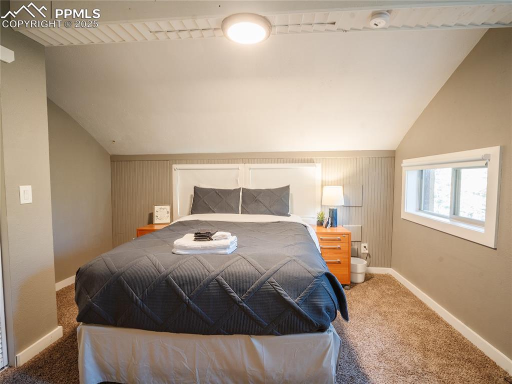 57 Granite Road Florissant, CO 80816 - Photo 32 of 46 a bedroom with a bed and wooden floor