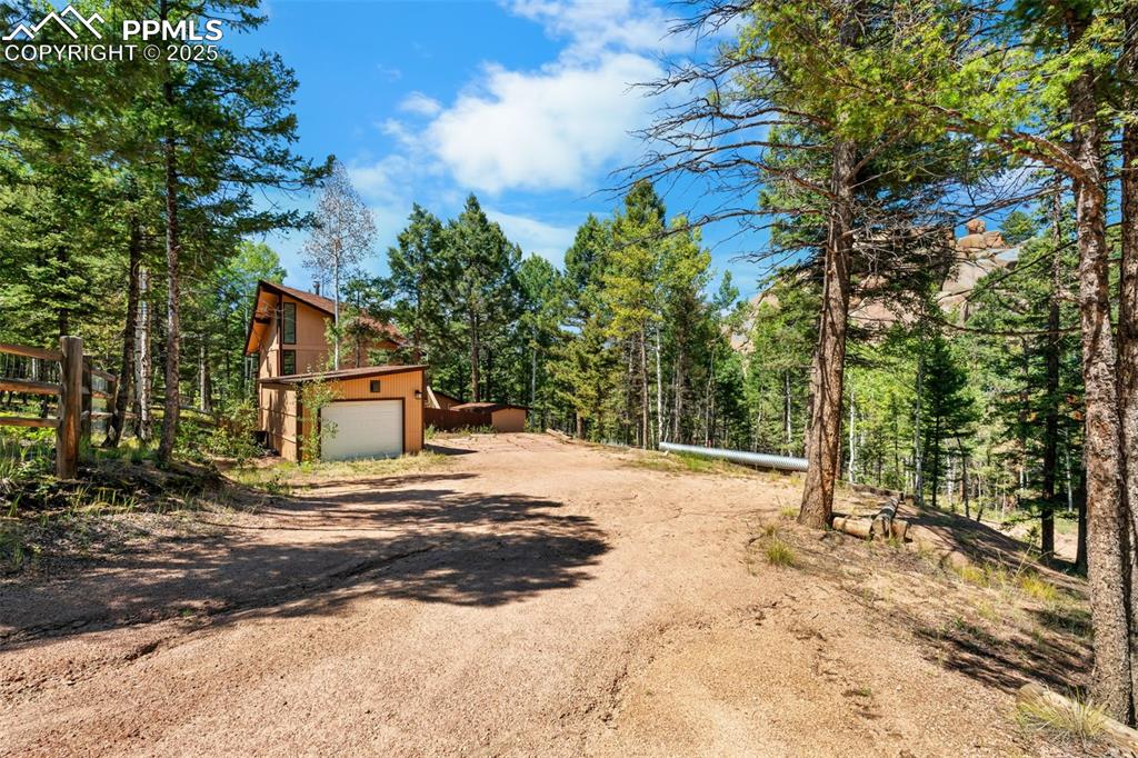 57 Granite Road Florissant, CO 80816 - Photo 44 of 46 a front view of a house with a yard and garage