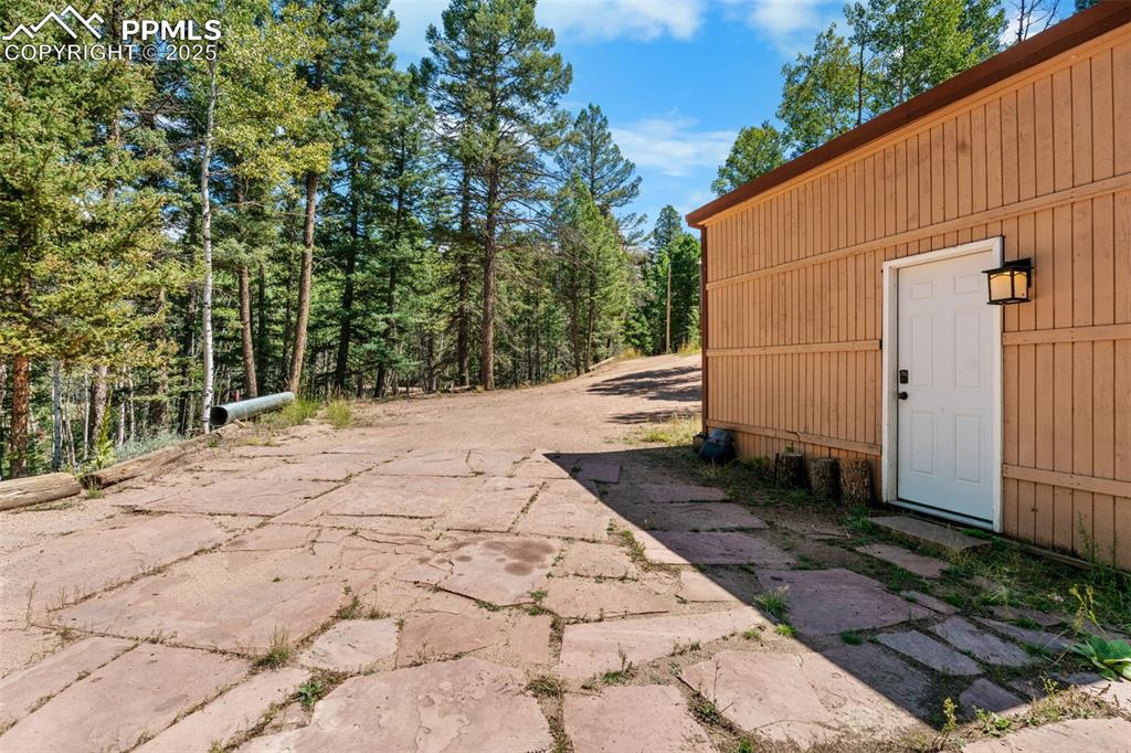 57 Granite Road Florissant, CO 80816 - Photo 45 of 46 a backyard of a house with large trees and wooden fence