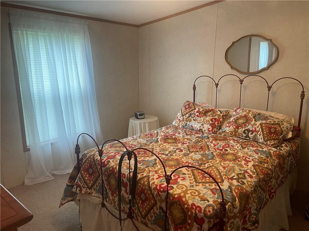 14624 Gilliland Road Linesville, PA 16424 - Photo 17 of 23 a bed sitting in a bedroom next to a window