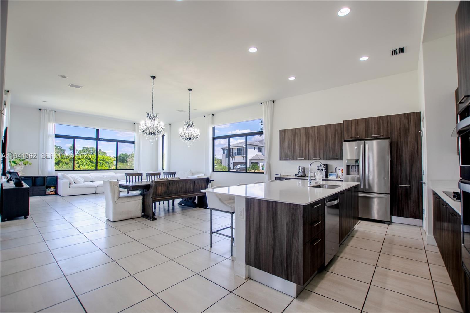 15821 Southwest 49th Street Southwest Ranches, FL 33331 - Photo 11 of 67 a kitchen with a stove a refrigerator and a dining table