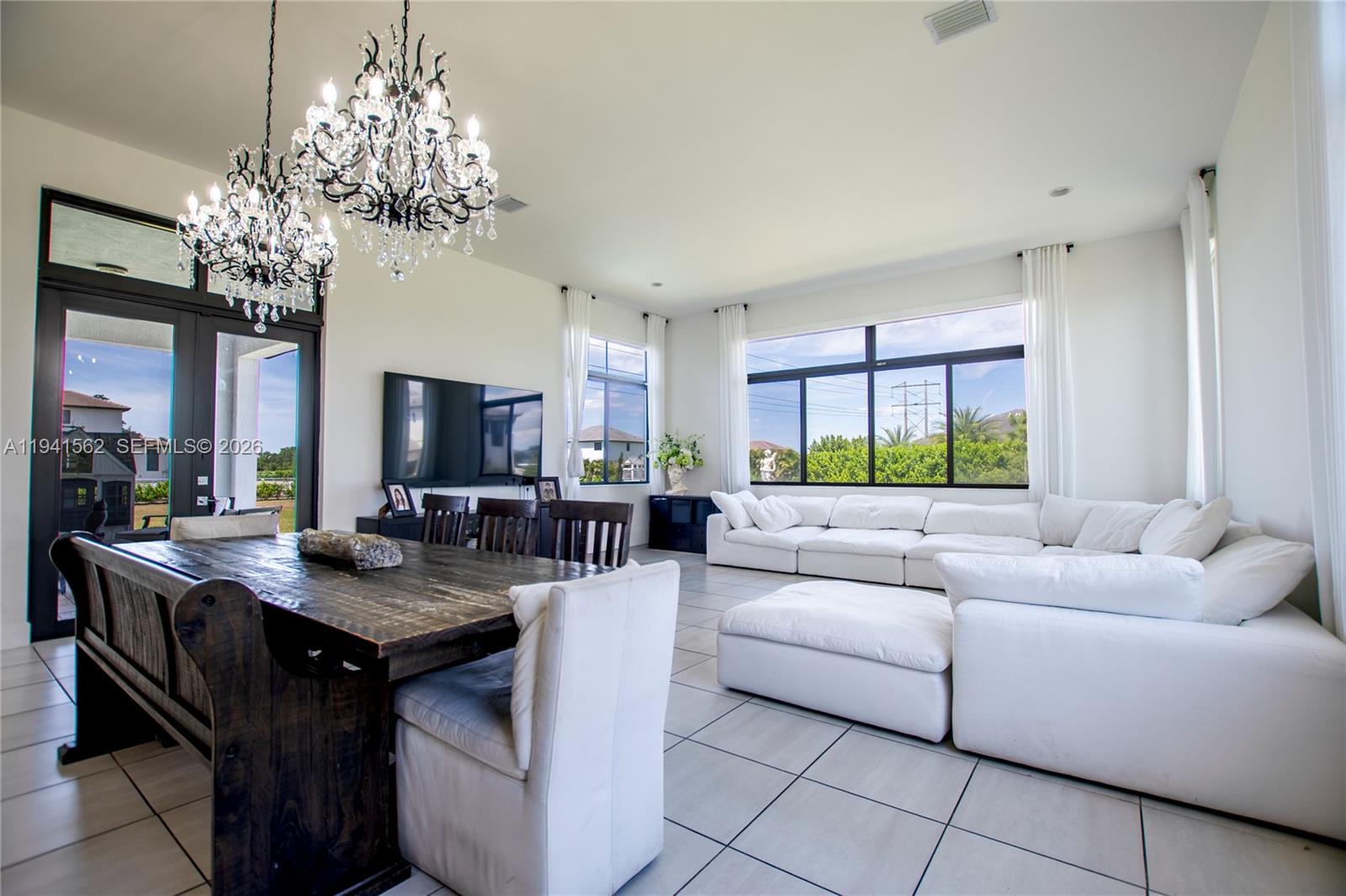 15821 Southwest 49th Street Southwest Ranches, FL 33331 - Photo 16 of 67 a living room with fireplace furniture and a chandelier