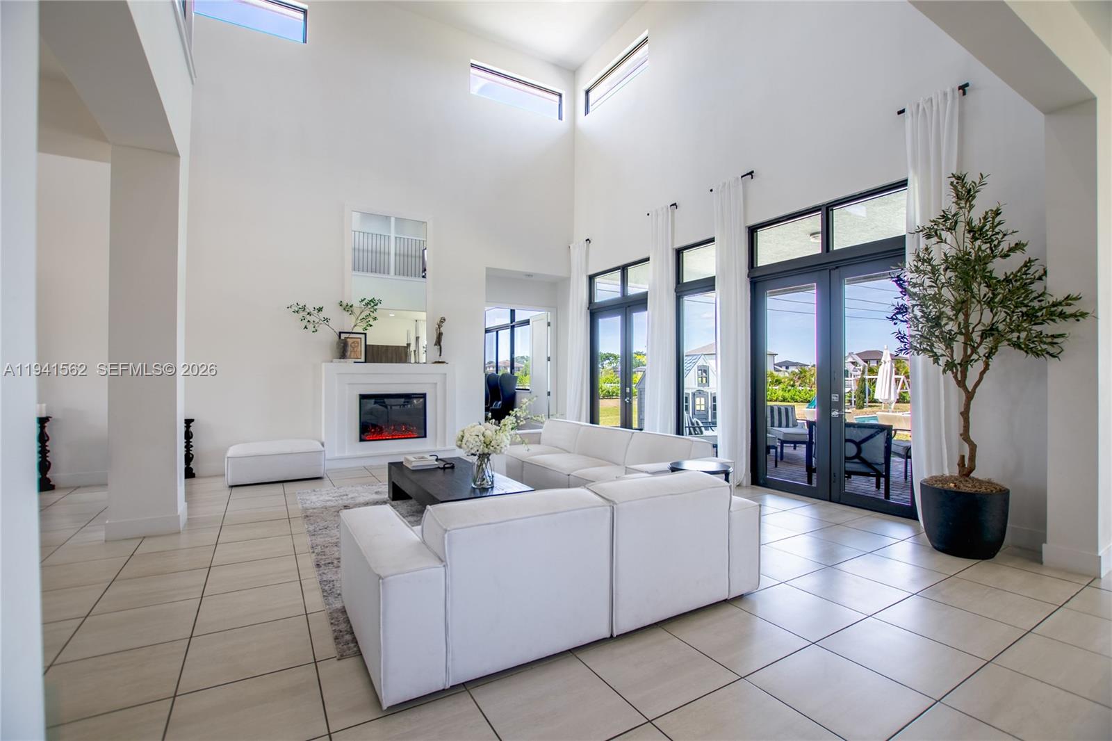 15821 Southwest 49th Street Southwest Ranches, FL 33331 - Photo 20 of 67 a living room with furniture a fire pit and a potted plant