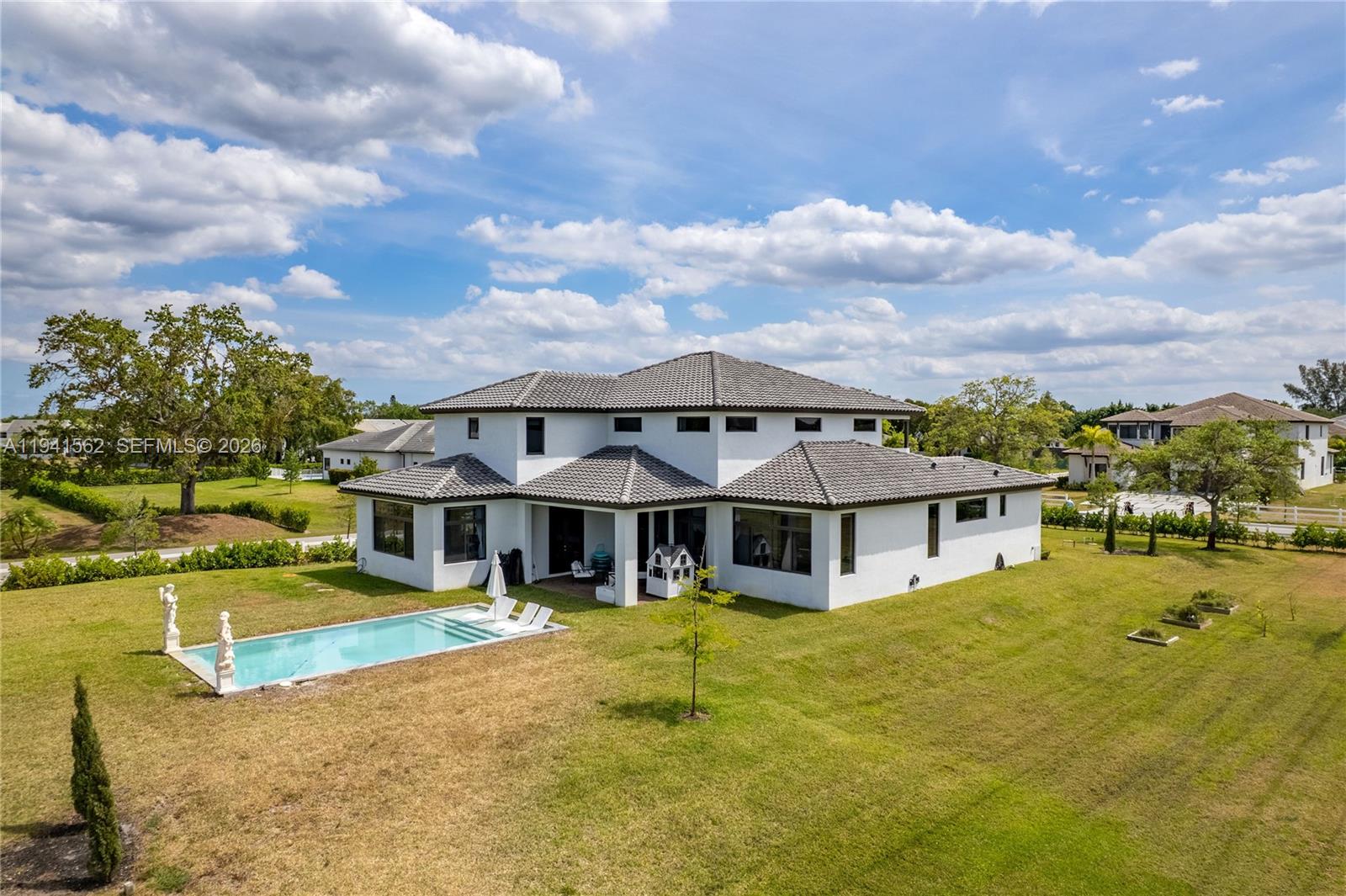 15821 Southwest 49th Street Southwest Ranches, FL 33331 - Photo 2 of 67 a view of house with a big yard and large trees