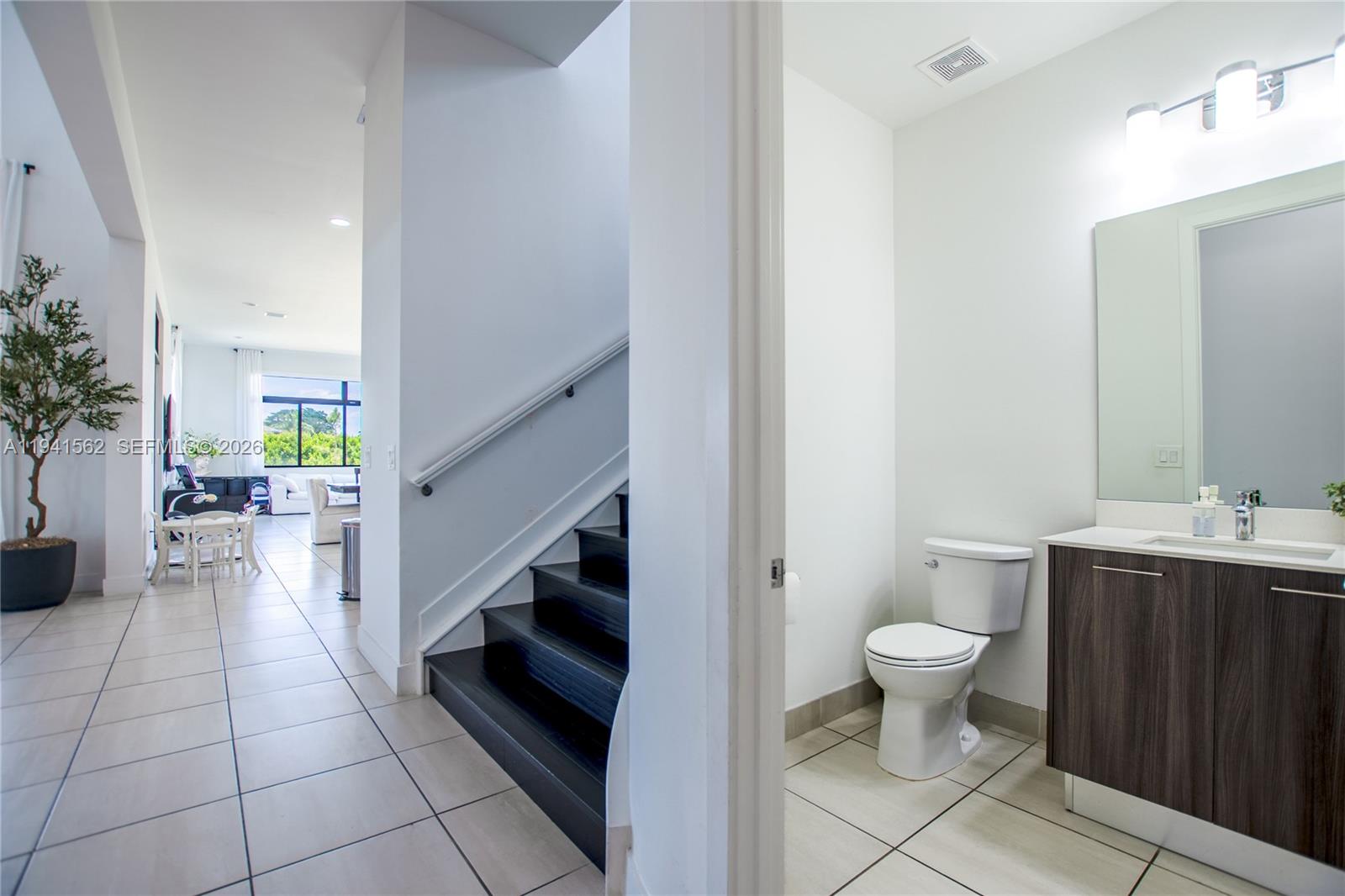 15821 Southwest 49th Street Southwest Ranches, FL 33331 - Photo 21 of 67 a bathroom with a sink a toilet and a mirror